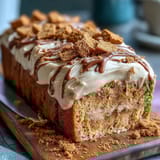 Decadent Baked Biscoff Cake with Creamy Lotus Frosting is dusted with crumbs, showcasing its moist, tender crumb texture.