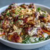 Brightly colored Peanut Chicken Protein Bowl with sautéed chicken, fluffy coconut rice, crisp red cabbage, and carrots.