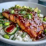 Glazed salmon fillet and crisp cucumbers combine in a colorful Honey Sriracha Salmon Bowl with sriracha mayo.