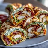 Vibrant turkey and cheese pinwheel sandwiches with colorful veggies, perfect for kid lunches or party trays.  