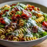 Creamy avocado ranch coats rotini pasta, bacon, lettuce, and tomatoes for a refreshing BLT pasta salad twist.  