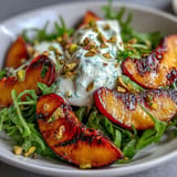 Creamy burrata and smoky grilled peaches create a delicious summer salad experience.