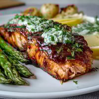 Aromatic garlic butter salmon and tender asparagus roast together for a golden, flavorful dinner.