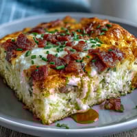 Hearty Overnight Amish Breakfast Casserole with sausage, eggs, and melted cheese, perfect for feeding a crowd in the morning.